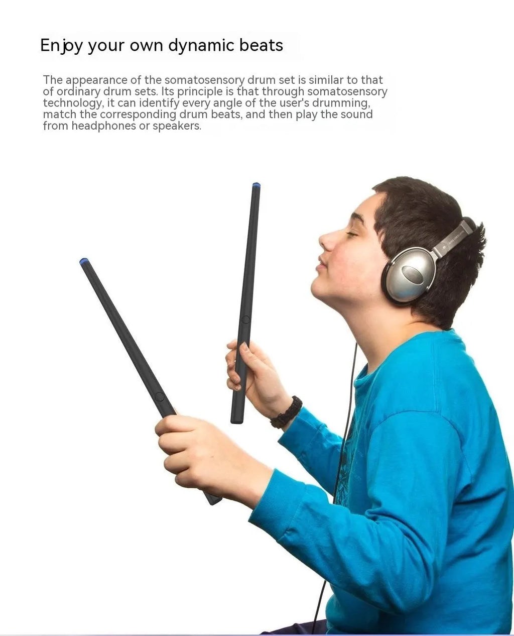 Black wireless air drum kit with drumsticks and headphones on table