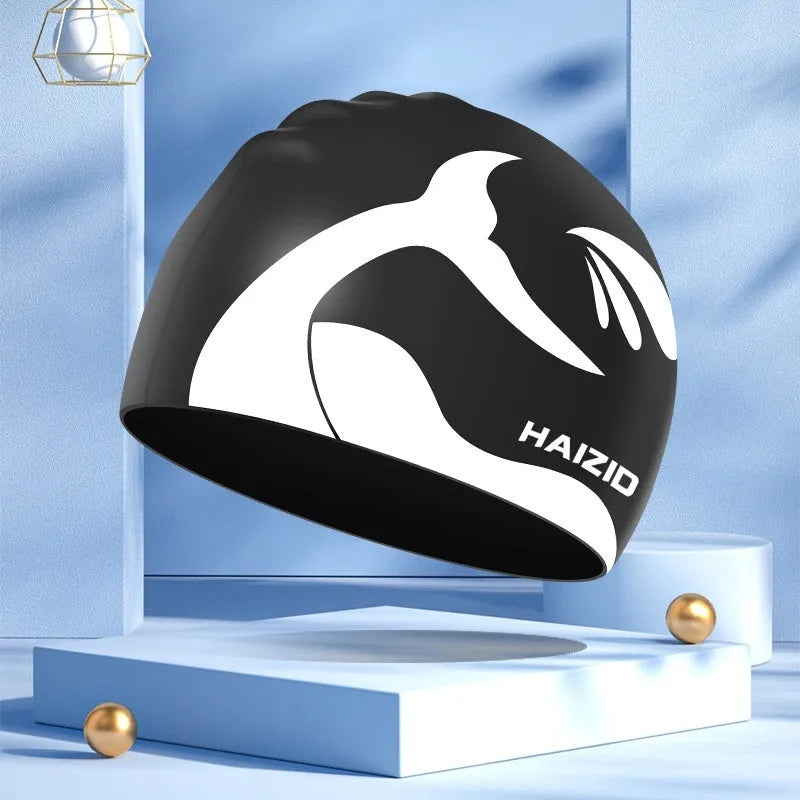 Silicone swimming cap with waterproof ear protectors featuring whale tail pattern in multiple colour options