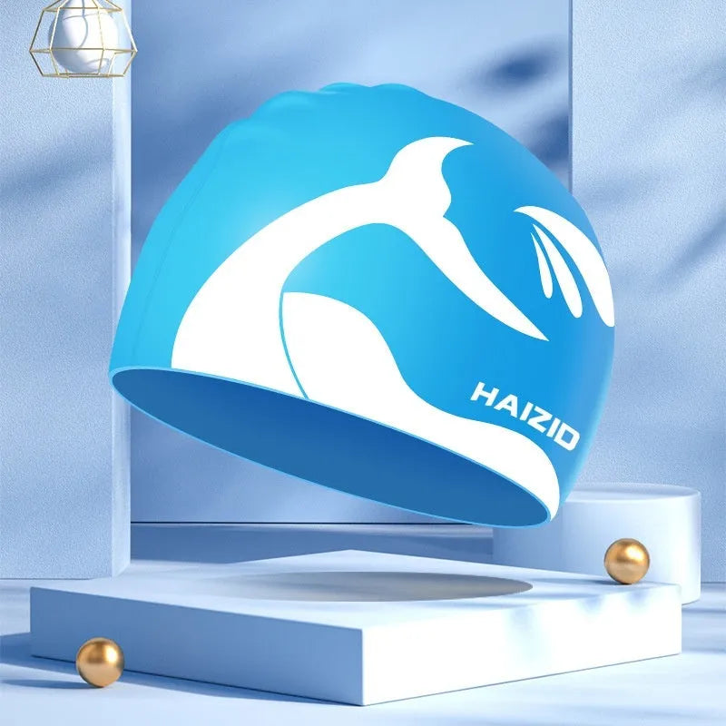Silicone swimming cap with waterproof ear protectors featuring whale tail pattern in multiple colour options