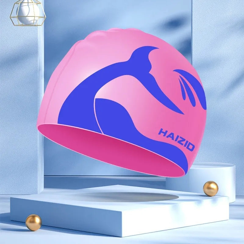 Silicone swimming cap with waterproof ear protectors featuring whale tail pattern in multiple colour options