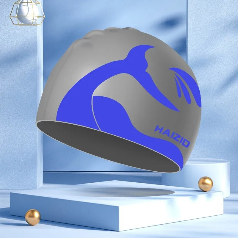 Silicone swimming cap with waterproof ear protectors featuring whale tail pattern in multiple colour options