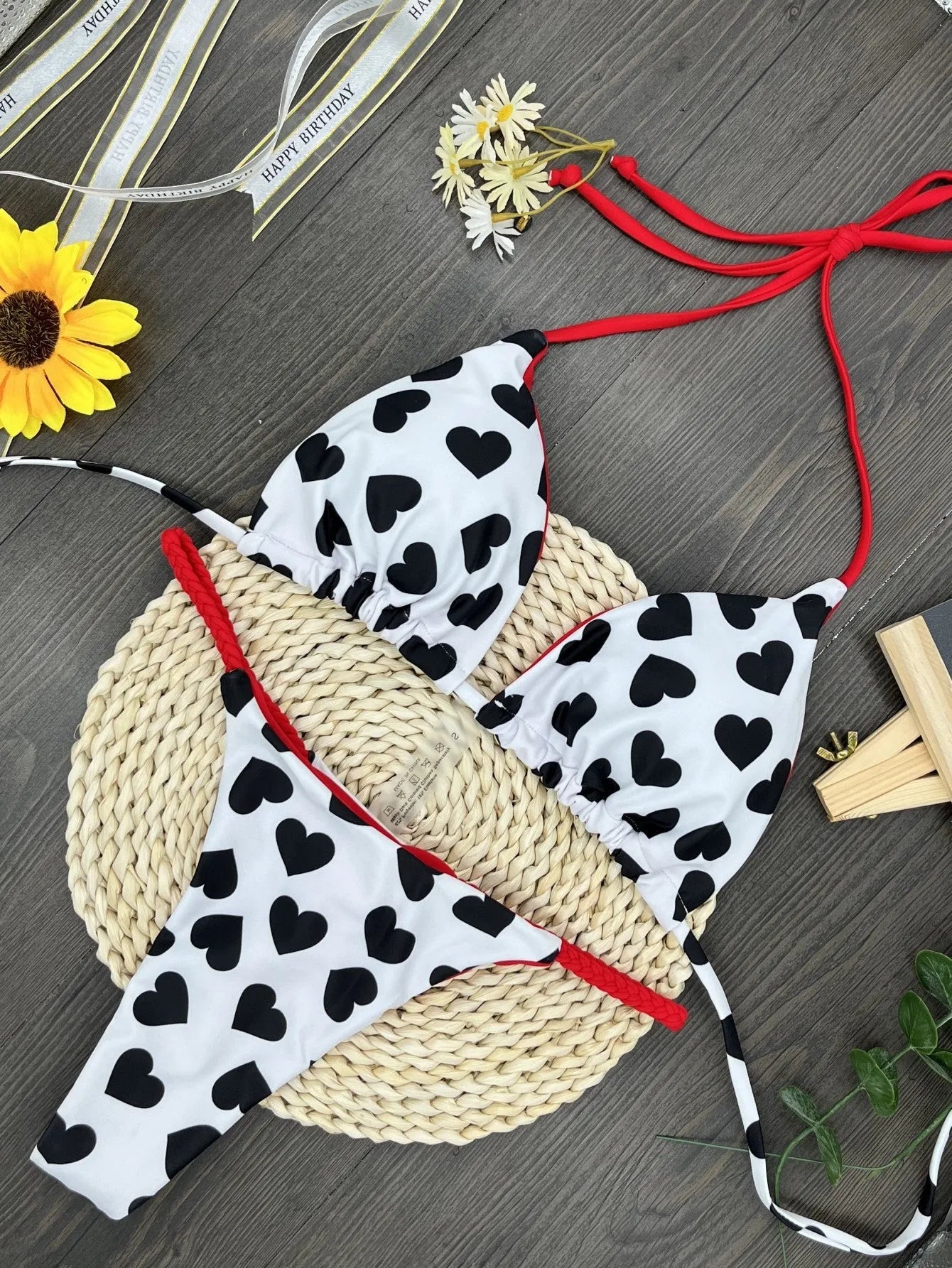 Heart print backless one-piece swimsuit with high side splits on a model