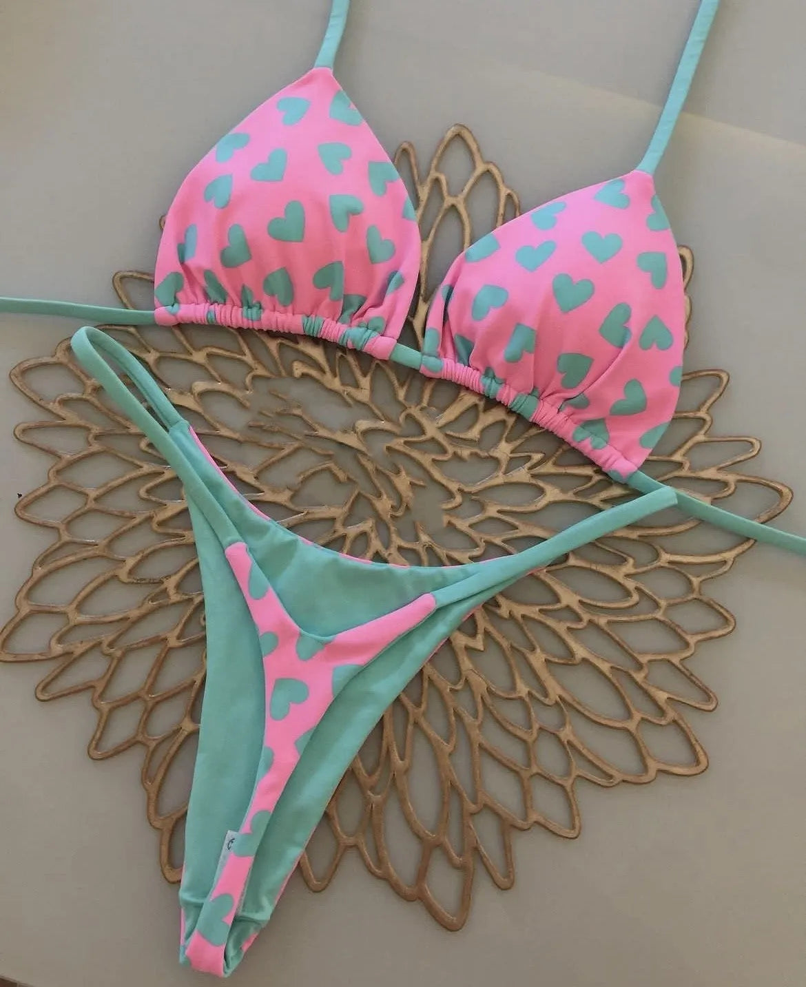Heart print backless one-piece swimsuit with high side splits on a model