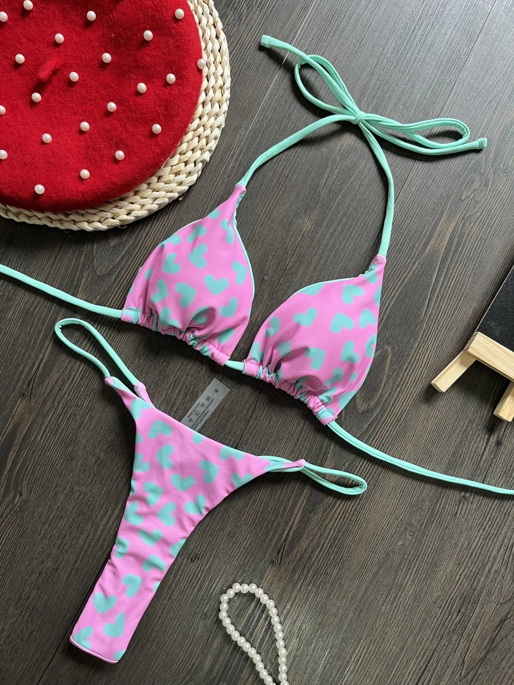 Heart print backless one-piece swimsuit with high side splits on a model