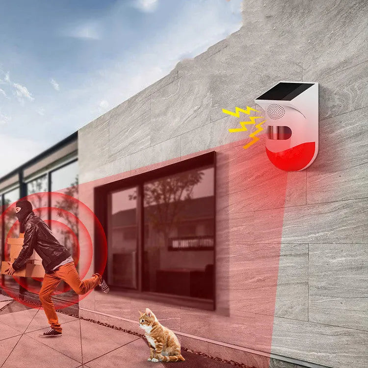 Solar panel human body infrared sensing security alarm with remote control on a wall.