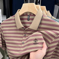A man wearing a blue striped short sleeve casual top with a mosaic pattern design.