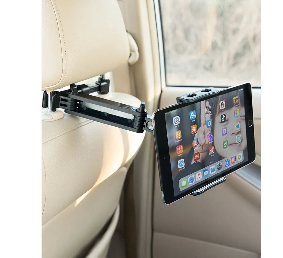 Black universal car phone holder mounted on a rear car seat, holding a tablet for navigation.