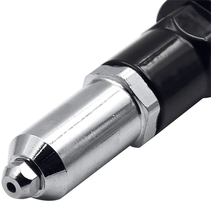 Black metal electric drill attachment rivet gun with handle, wrench, and rivet heads on a workshop bench.