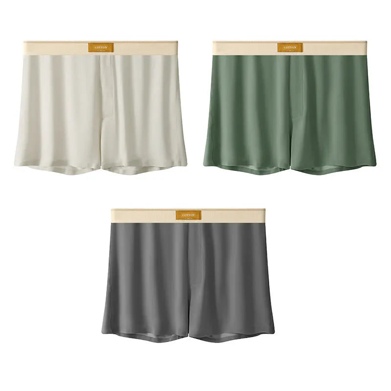 Three pairs of men's solid colour ice silk briefs on a grey background.