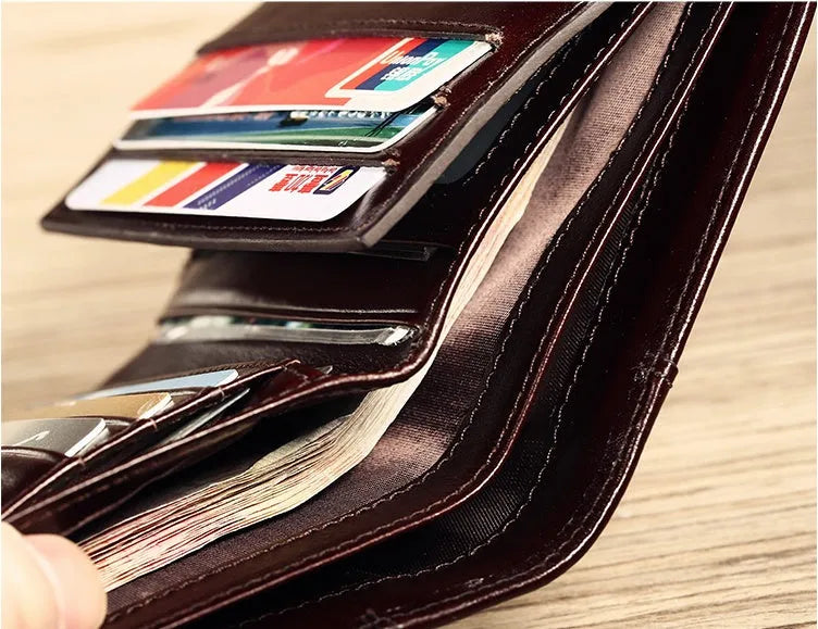 Men's leather organiser wallet open to show internal compartments including card slots and a zipped coin pocket.