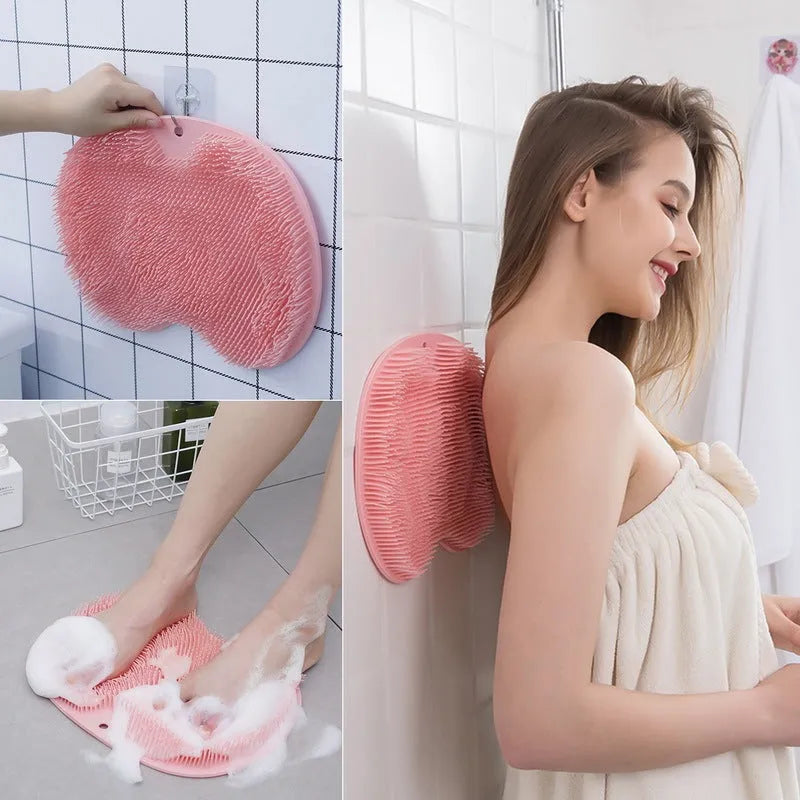 Orange silicone bath brush with suction cups on back and hundreds of small bristles for cleaning feet and back.