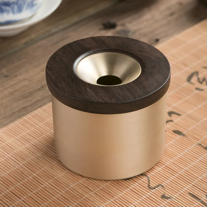 Retro solid copper ashtray with a wooden lid showing the centre hole.