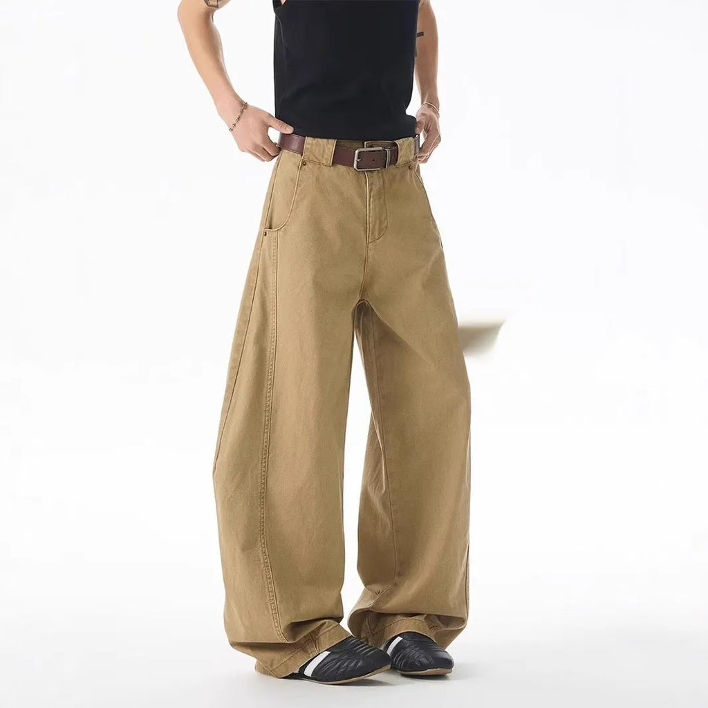 Brown men's straight-leg denim jeans with a loose fit and button fly on a neutral background.