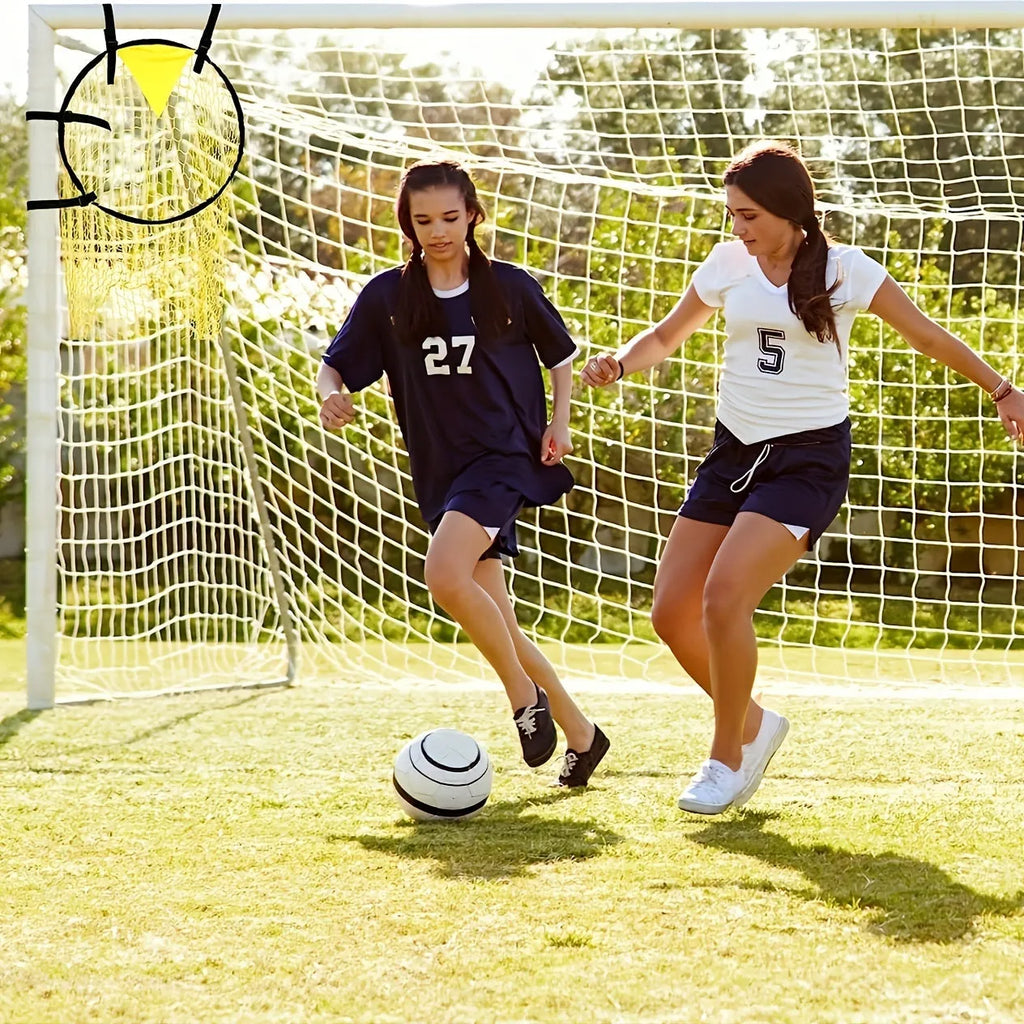 A portable black and yellow soccer training goal net with a steel frame set up on grass.