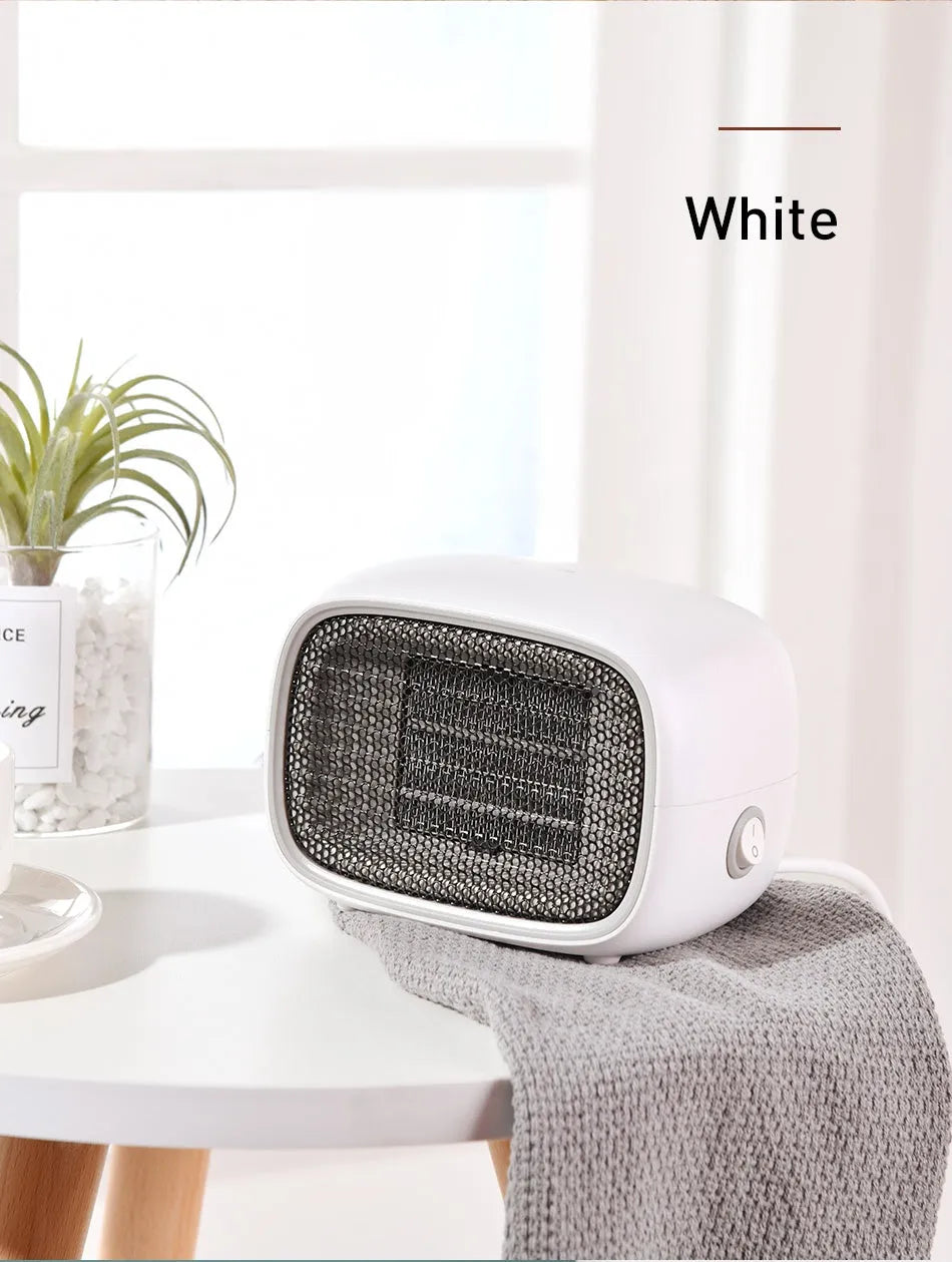 Compact green portable heater with metal grille showing dimensions 158mm x 90mm x 114mm.