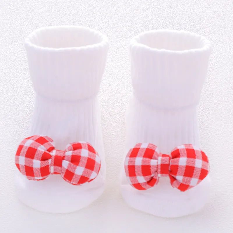 Cotton baby floor socks in a selection of colours and patterns like panda, lion, and bows, shown in sizes for infants.