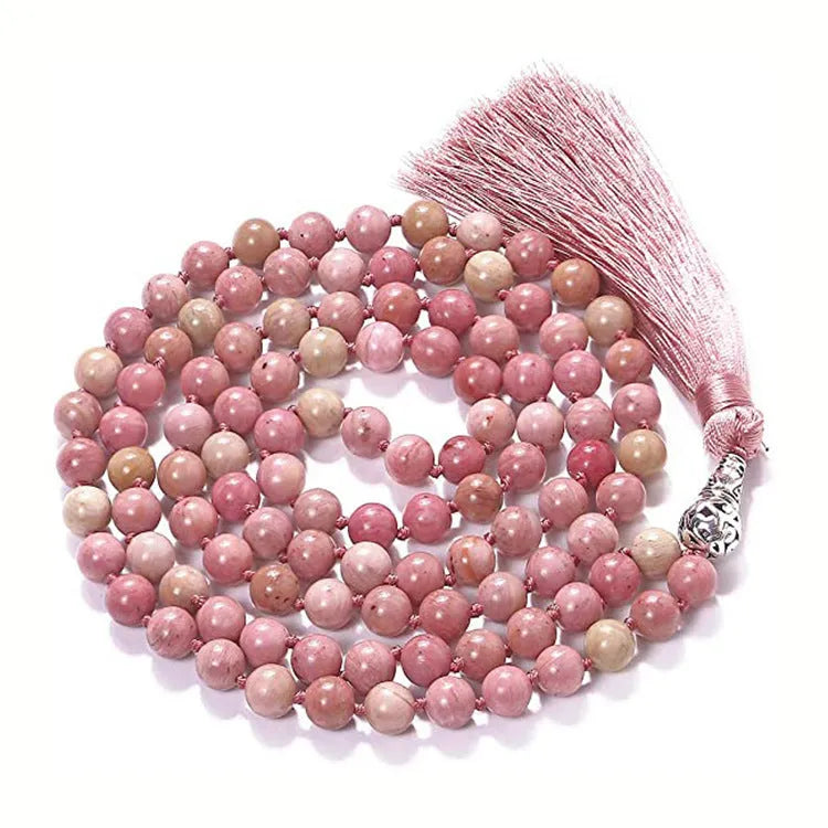 Long blue patterned agate and stone tassel necklace with geometric beads on a white background.