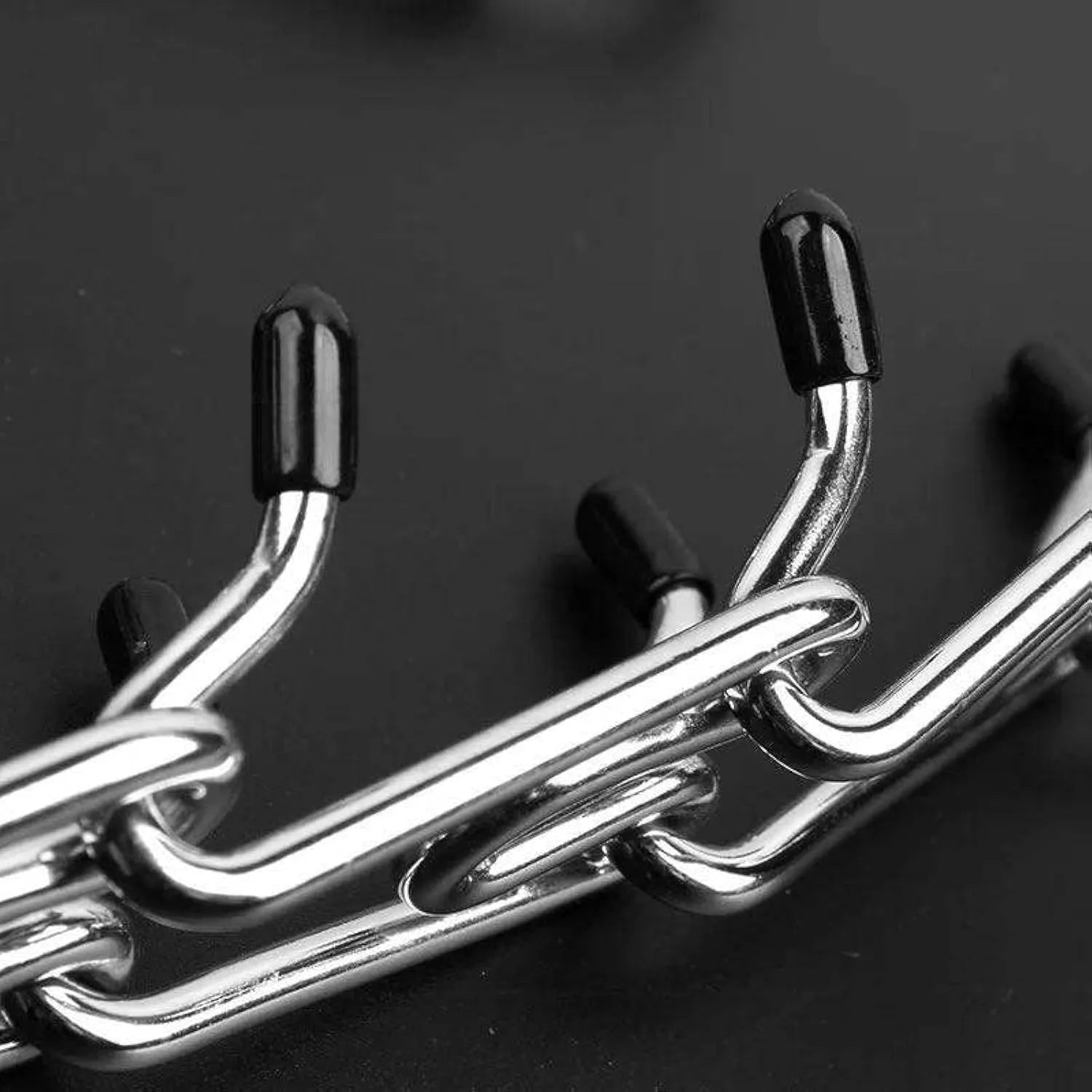 Stainless steel dog pinch training collar with round links and rubber tips, shown adjustable for medium or large breeds.