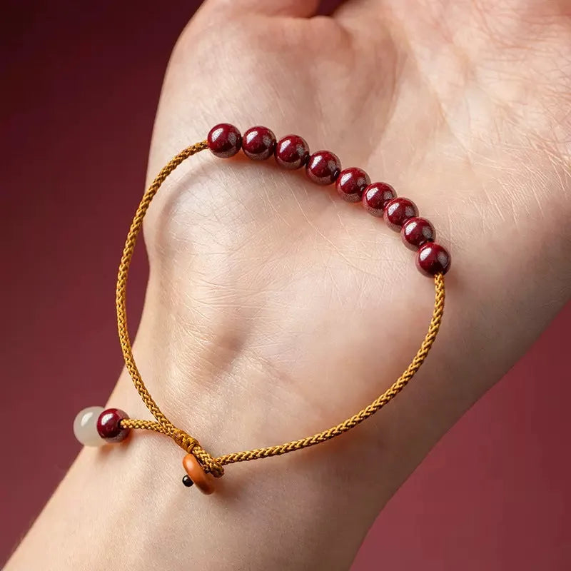 Hand-woven geometric bracelet made from raw red cinnabar ore on an adjustable cord.