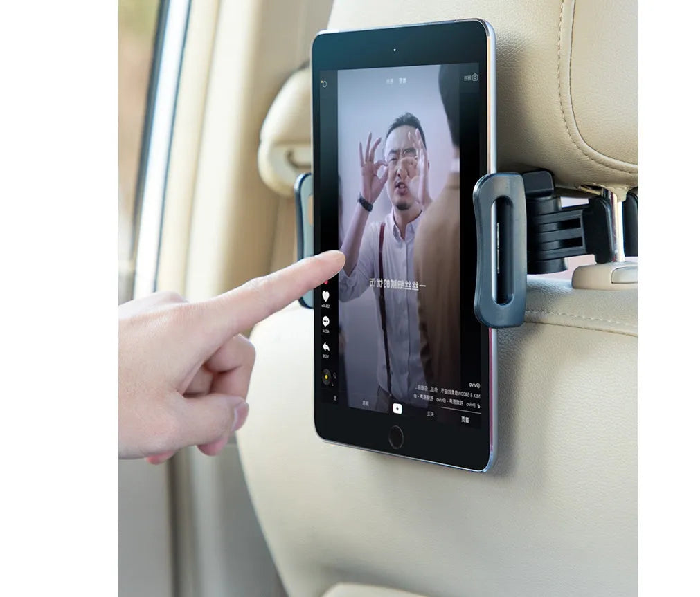 Black universal car phone holder mounted on a rear car seat, holding a tablet for navigation.