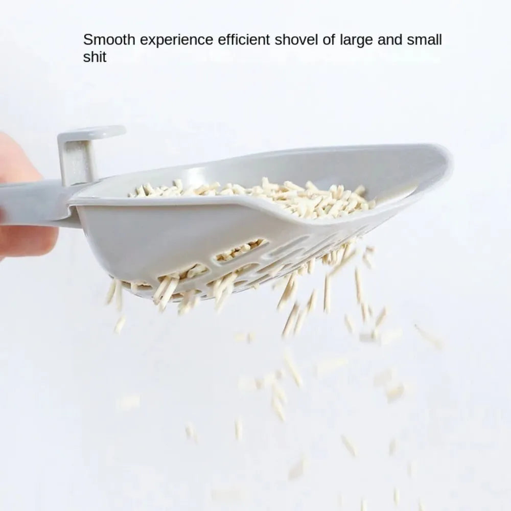 Gray plastic cat litter scoop with matching upright base for self-cleaning kitten toilet maintenance