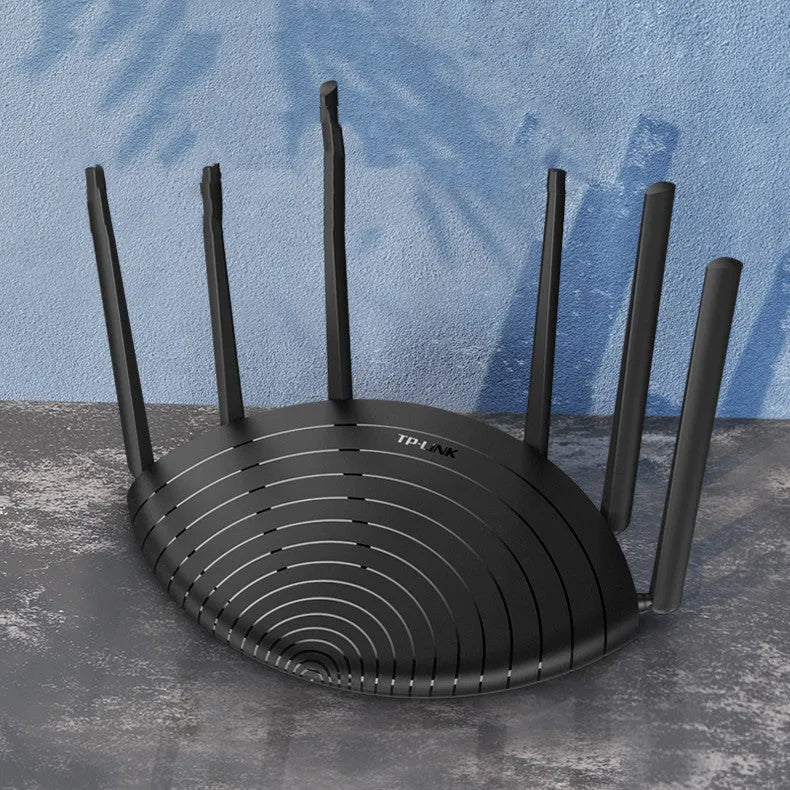 TP-Link TL-WDR7661 AC1900 wireless gigabit router on a desk, showing Ethernet ports and compact size.