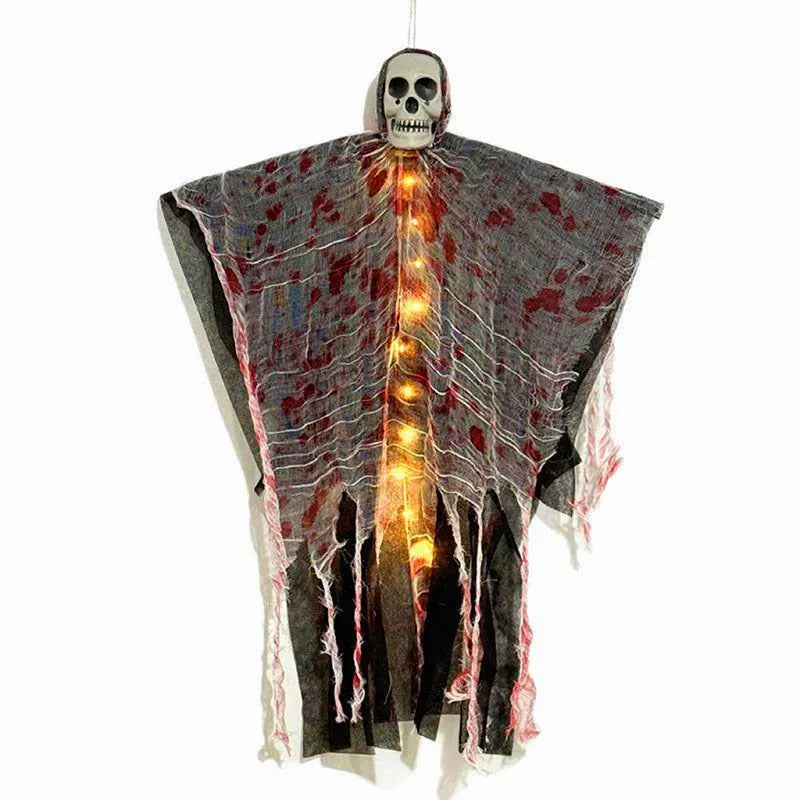 Halloween decoration showing a luminous blood-dyed plastic skull with a hanging ghost outdoor ornament