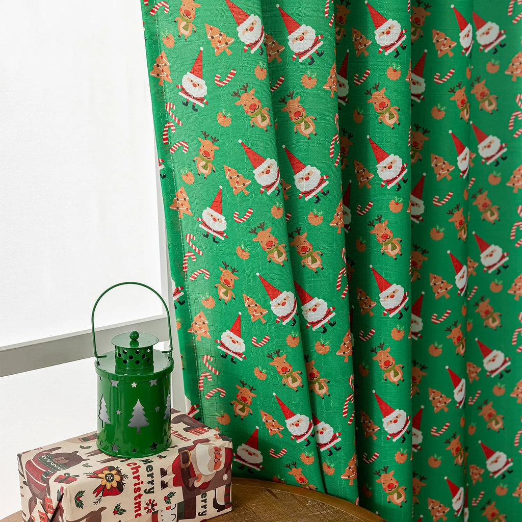 Green Christmas curtain with printed cartoon snowman and angel figures