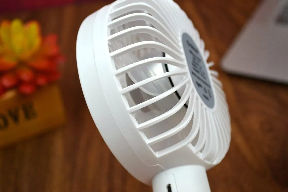 ORICO FH1 white portable USB rechargeable fan with three-speed settings on a desk.