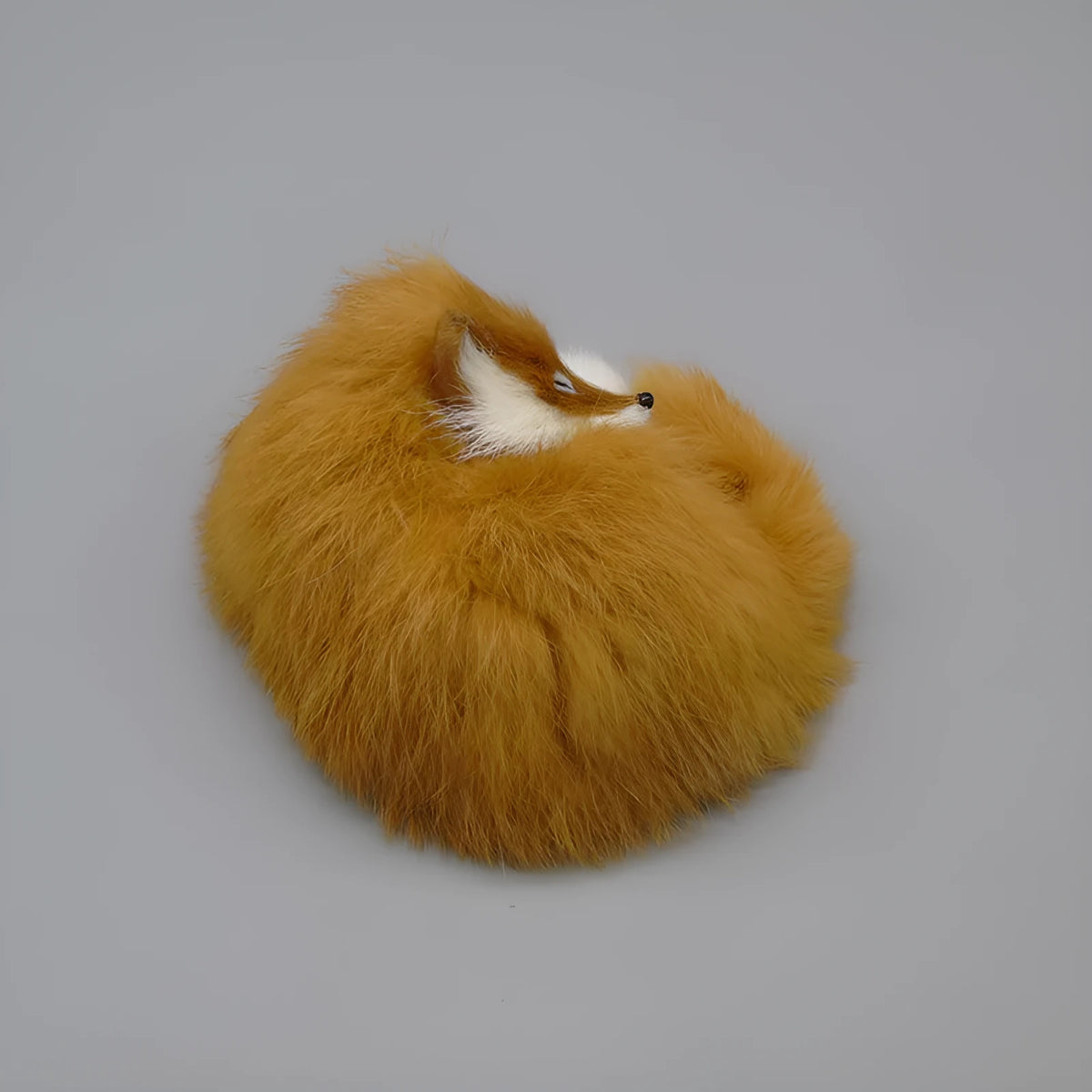 Artificial white fox fur car ornament measuring 15cm long on dashboard