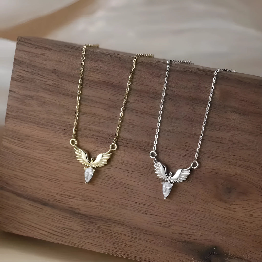 Sterling silver eagle pendant necklace with an O-ring chain on a model, showing white gold colour finish.