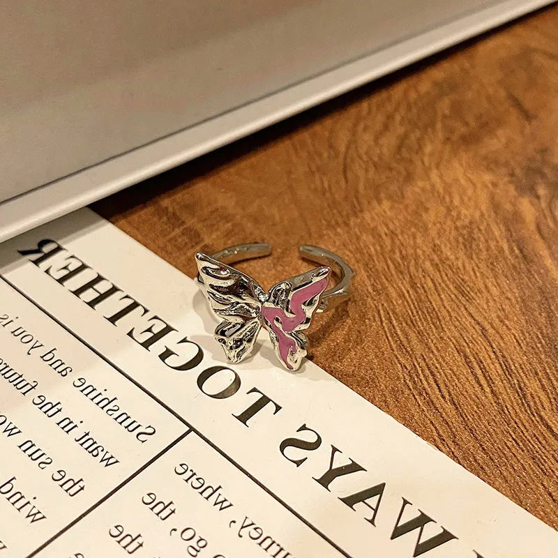 Copper butterfly women's ring with drip oil finish in an open-loop design.