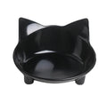 Shallow black melamine pet bowl with a non-slip rubber base on a kitchen floor.