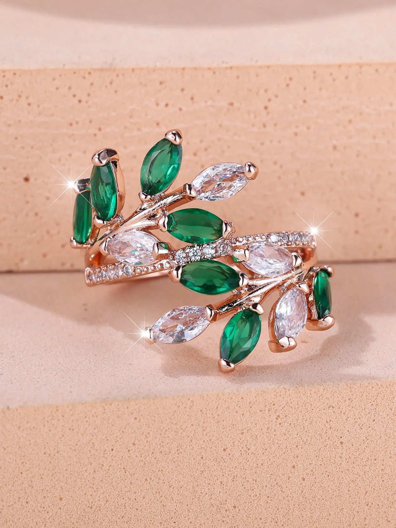 Adjustable copper leaf ring with zircon detailing in multiple colour options on display