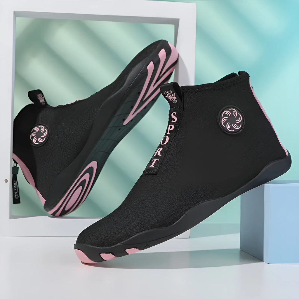 Men's black and fluorescent green quick-dry mesh beach shoes with a non-slip rubber sole on a rocky surface.