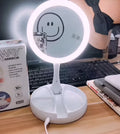 White foldable double-sided LED vanity mirror with built-in storage compartments and USB cable.