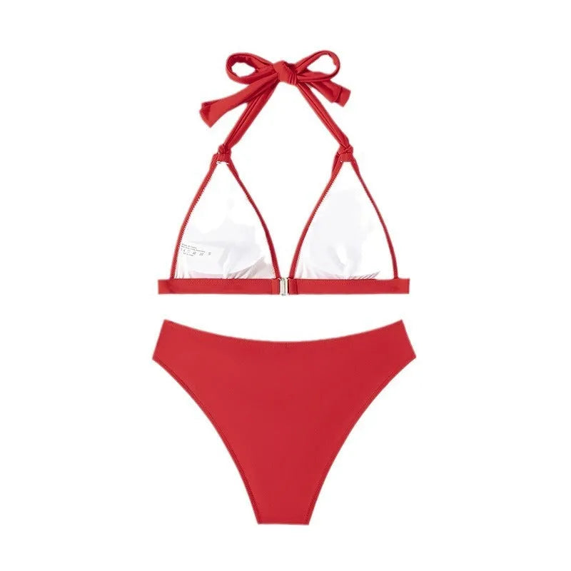 Red women's lace-up halterneck bikini set with split-bottom shorts on mannequin