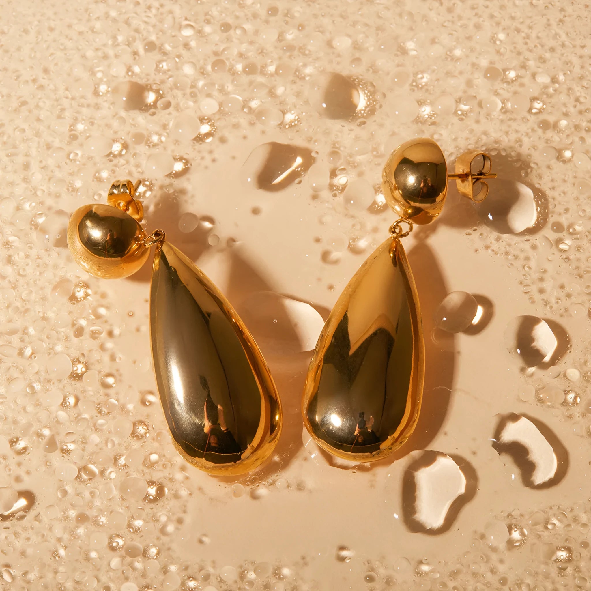 Gold stainless steel water drop hemisphere earrings with geometric design