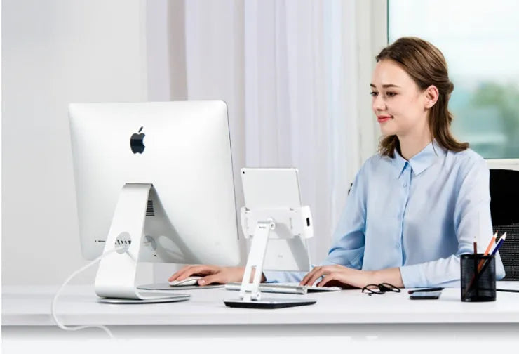 Foldable aluminium desktop phone and tablet holder in silver showing 360-degree rotation