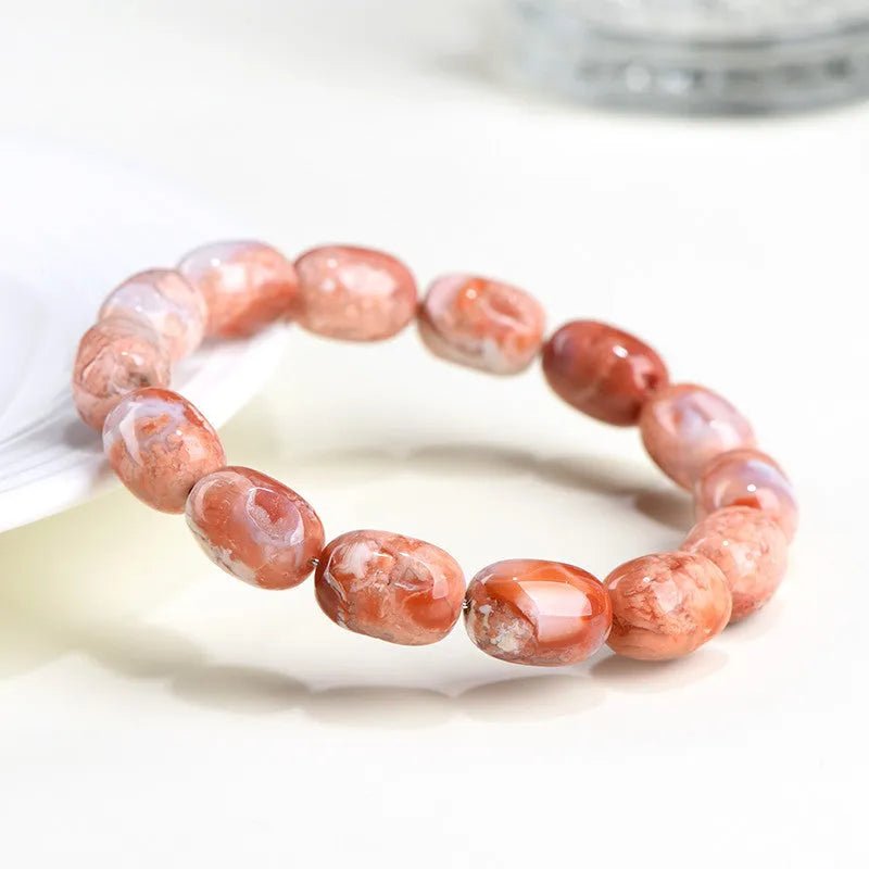 Natural cherry agate barrel bead bracelet with Ruyi elements measuring 10x14mm