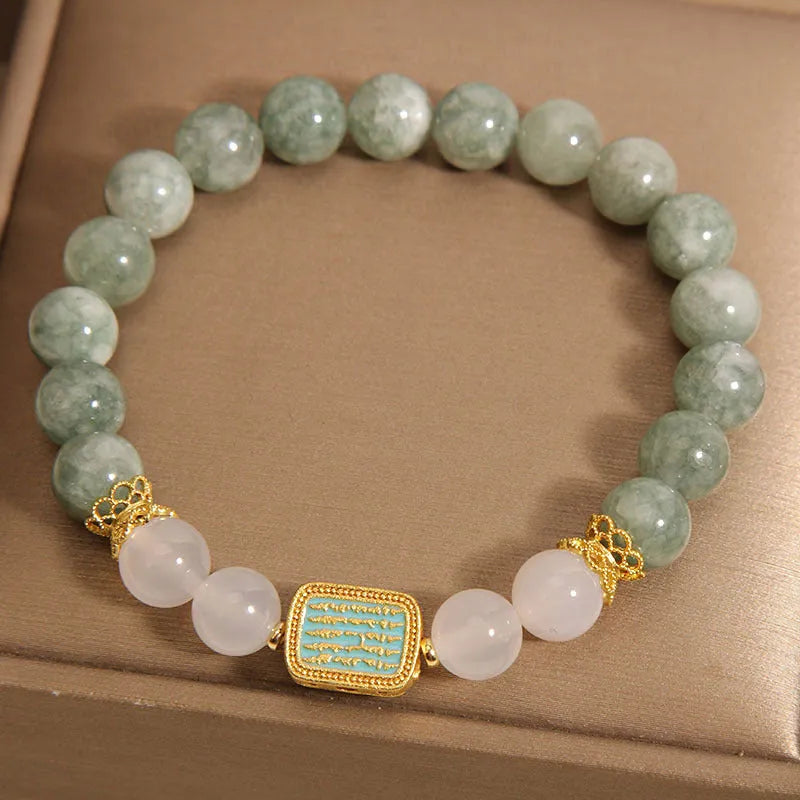 Oil green emerald crystal bracelet for women with five engraved beads.