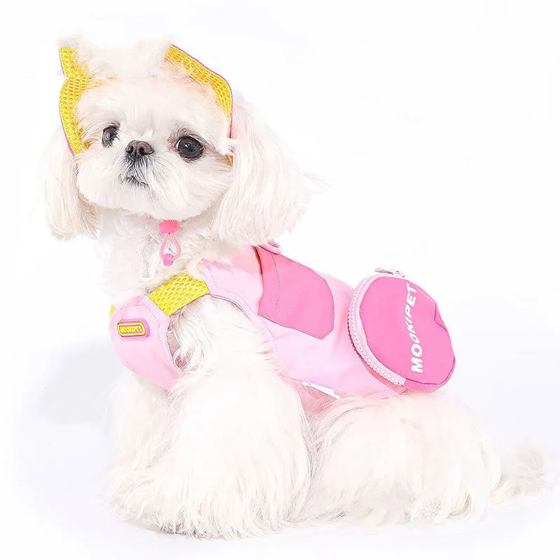 Pink polyester traction vest for a small white dog on a grey background.