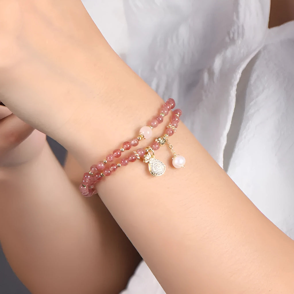 Women's geometric strawberry quartz crystal bracelet for money drawing and luck.