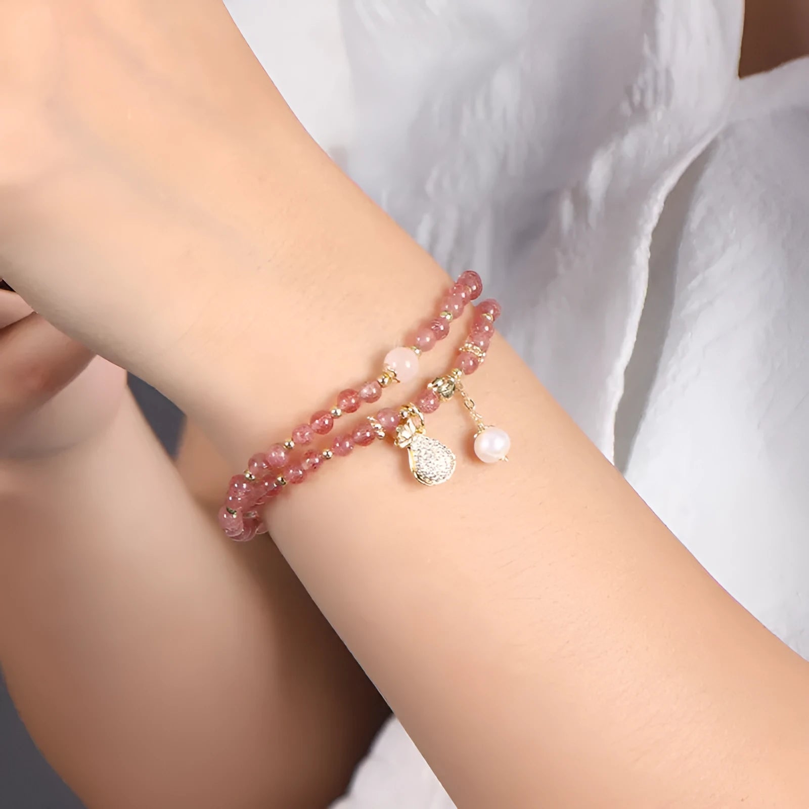 Women's geometric strawberry quartz crystal bracelet for money drawing and luck.