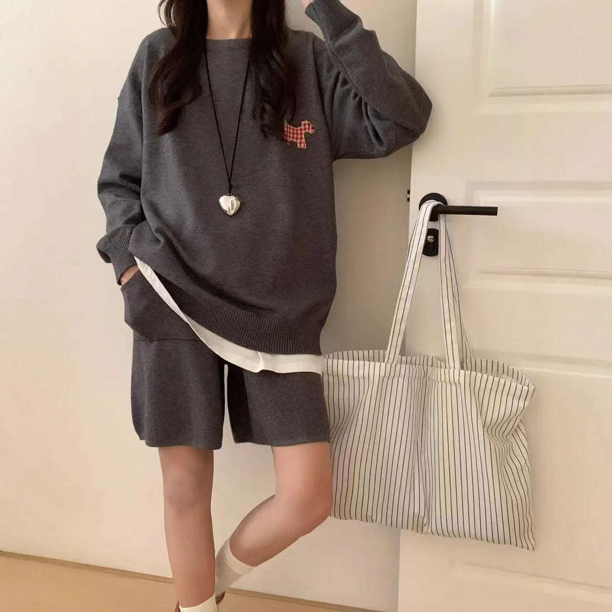 Women's milk blue knitted sweater and shorts loungewear set with embroidered animal pattern.