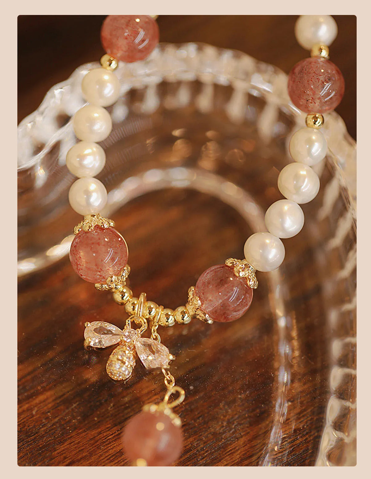 Strawberry quartz crystal bracelet with stringed pearls and bow detail