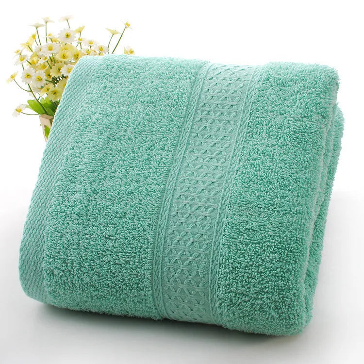 Thickened cotton blend bath and beach towel shown in multiple colour options including green, blue, and pink variations.
