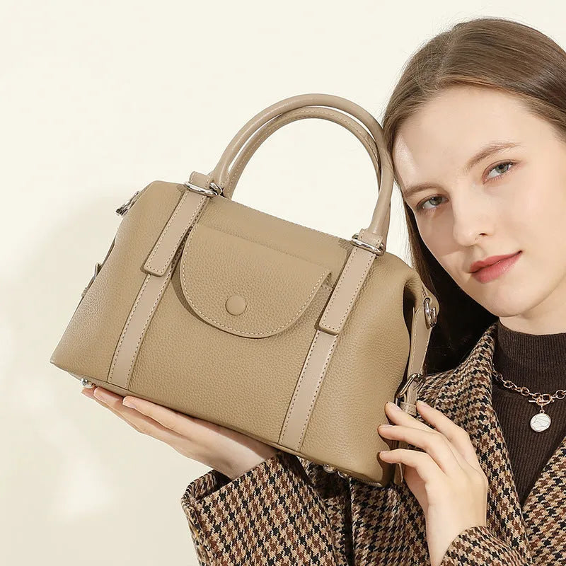 Genuine leather ladies shoulder bag in street trend style with lock detail and contrast stitching.