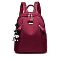 Medium square grey Oxford cloth rucksack with double straps, shown open to reveal internal phone and organiser pockets.