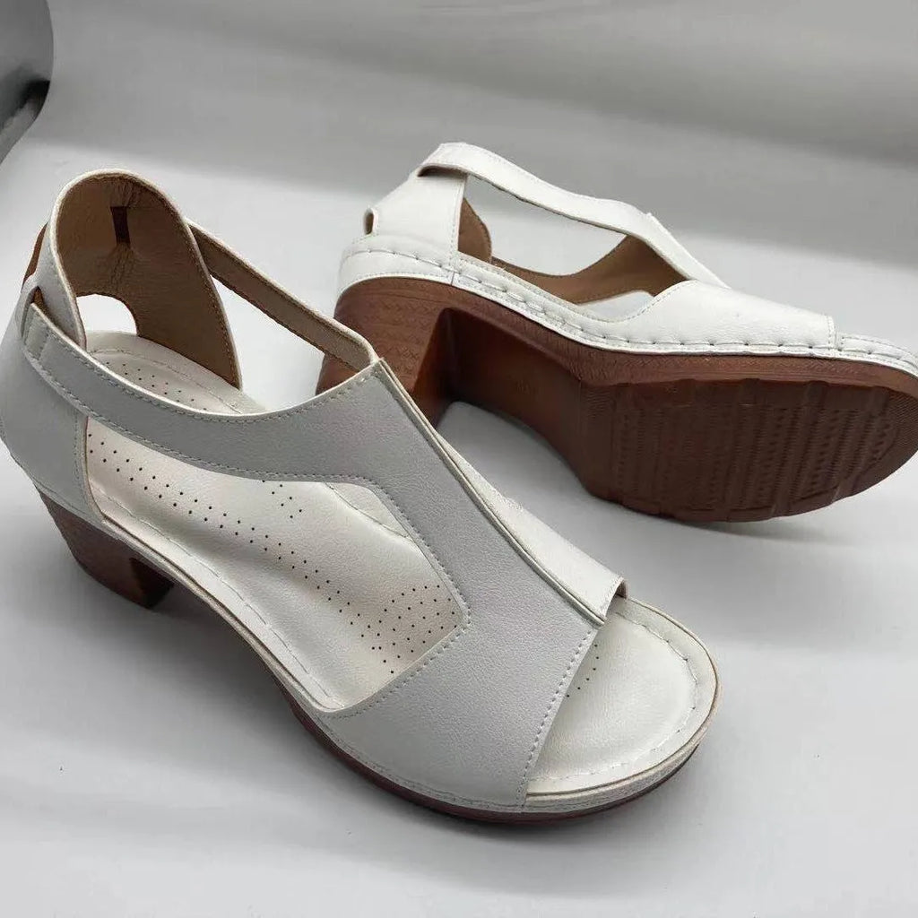 Plus size beige wedge sandals with peep toe, open sides, and a Roman-style ankle buckle.